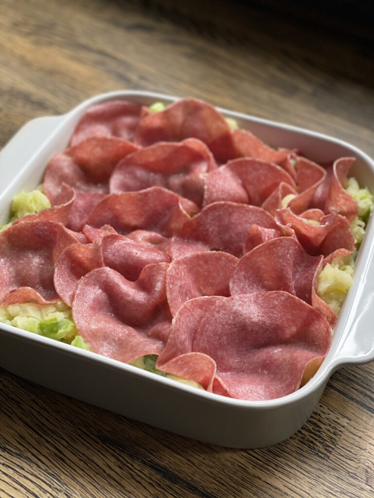 ovenschotel met aardappelpuree, prei, salami en bechamelsaus