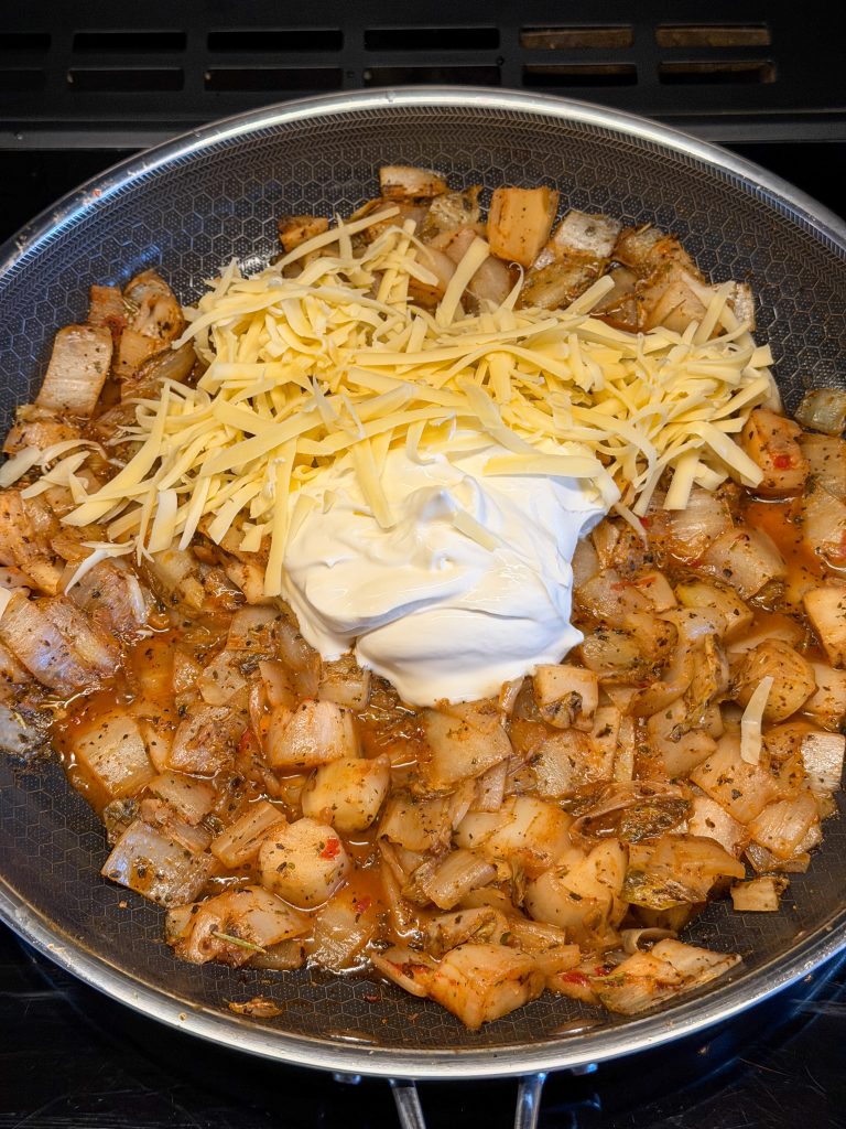 Crème fraîche en geraspte kaas door gebakken witlof