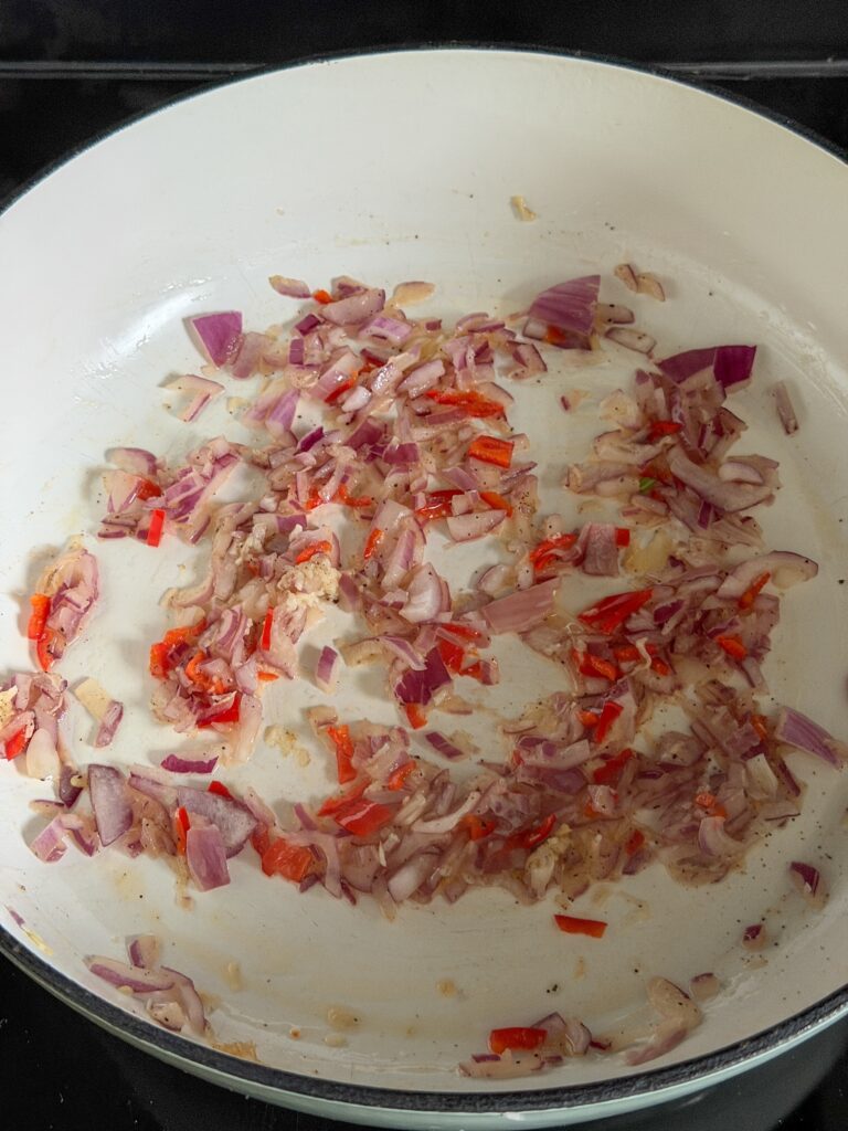 Rode ui, knoflook en rode peper aanfruiten